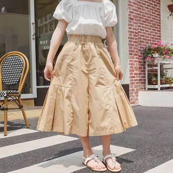 Широкие свободные юбки для девочек, Корейская уличная одежда с высокой талией, нерегулярные плиссированные сращивания, повседневные Летние Новые укороченные брюки 2023
